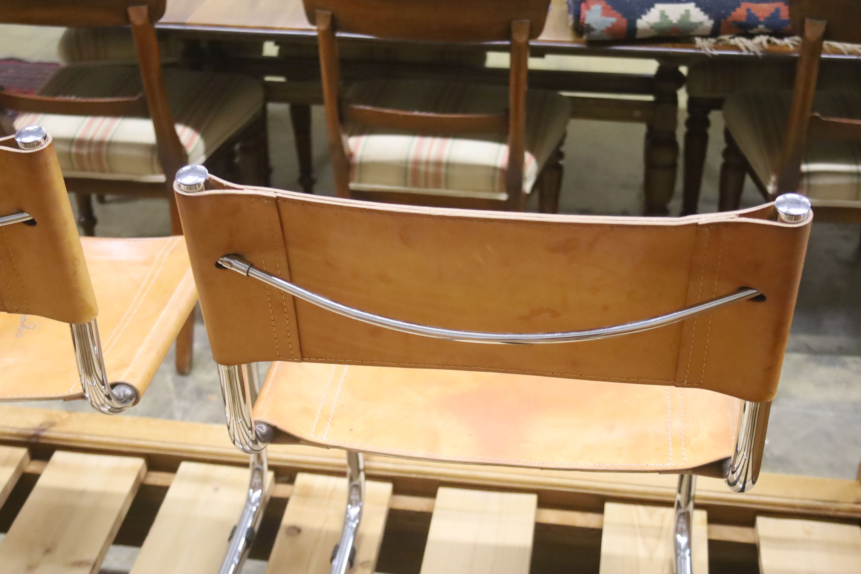 A set of six Italian design tan leather and chrome cantilever dining chairs, width 48cm, depth 44cm, height 77cm